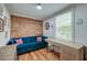 Comfortable living room with hardwood floors, a brick accent wall, and lots of natural light at 3.5 Kracke St # C, Charleston, SC 29403