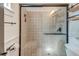 Bathroom featuring a tiled shower with glass door, modern fixtures, and neutral color palette at 3.5 Kracke St # C, Charleston, SC 29403