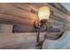 Detailed shot of a stylish wall sconce on a wood accent wall, adding character to the bedroom at 3.5 Kracke St # C, Charleston, SC 29403