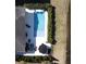 An aerial view shows a private backyard pool and patio, edged by hedges and lawn to the adjacent lake at 3608 Maidstone Dr, Mount Pleasant, SC 29466