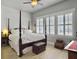 Comfortable bedroom with a four-poster bed, shuttered windows, and ample natural light at 3608 Maidstone Dr, Mount Pleasant, SC 29466