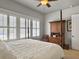 Cozy bedroom with a four-poster bed, shuttered windows, and wood floors at 3608 Maidstone Dr, Mount Pleasant, SC 29466