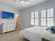 Well-lit bedroom with TV, white furniture, and windows dressed with white shutters at 3608 Maidstone Dr, Mount Pleasant, SC 29466