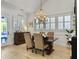 Bright dining room featuring a chandelier, wood floors, and large windows with plantation shutters at 3608 Maidstone Dr, Mount Pleasant, SC 29466