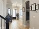 Bright foyer with hardwood floors, an elegant light fixture and staircase, showing a welcoming interior at 3608 Maidstone Dr, Mount Pleasant, SC 29466