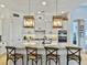 Bright kitchen with white cabinets, granite countertops, an island with barstool seating and pendant lights at 3608 Maidstone Dr, Mount Pleasant, SC 29466