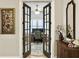 Double doors opening to a home office with a patterned rug and two monitors on the desk at 3608 Maidstone Dr, Mount Pleasant, SC 29466