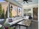 Comfortable screened porch with plush seating, stylish decor, and views of the landscaped backyard at 3608 Maidstone Dr, Mount Pleasant, SC 29466