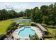 Aerial shot of community pool and tennis courts surrounded by green trees at 3924 Regal Oak Ln, Johns Island, SC 29455
