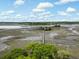 Scenic aerial view showcases the waterfront marshland, providing a glimpse of the serene natural surroundings at 3924 Regal Oak Ln, Johns Island, SC 29455