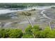 Aerial view of a marsh with a dock walkway reaching into the river at 3924 Regal Oak Ln, Johns Island, SC 29455