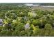 Expansive aerial view of wooded residential area with waterfront access and lush greenery at 3924 Regal Oak Ln, Johns Island, SC 29455