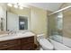 Well-lit bathroom with tiled shower and tub and a vanity with dark wood cabinets and light countertops at 3924 Regal Oak Ln, Johns Island, SC 29455