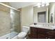 Well-maintained bathroom with tiled shower, and a vanity with dark wood cabinets and marble countertops at 3924 Regal Oak Ln, Johns Island, SC 29455