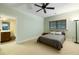 Comfortable bedroom featuring neutral carpet, a ceiling fan, and an ensuite bathroom at 3924 Regal Oak Ln, Johns Island, SC 29455
