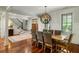 Elegant dining room showcasing hardwood floors, sophisticated lighting, and easy access to the entry at 3924 Regal Oak Ln, Johns Island, SC 29455