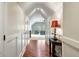 Bright hallway featuring hardwood floors, paneled walls, and an open view into a comfortably furnished room at 3924 Regal Oak Ln, Johns Island, SC 29455