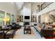 Inviting living room featuring built-in bookshelves, fireplace, high ceiling, and natural light at 3924 Regal Oak Ln, Johns Island, SC 29455