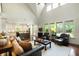 Airy living room showcasing large windows, comfortable seating, and seamless flow to the kitchen at 3924 Regal Oak Ln, Johns Island, SC 29455