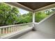 Inviting porch featuring white railings and a view of lush green trees at 3924 Regal Oak Ln, Johns Island, SC 29455
