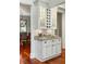 Stylish wet bar showcasing custom cabinets, granite countertop, and seamless access to the dining room at 3924 Regal Oak Ln, Johns Island, SC 29455