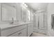 Modern bathroom with double sinks, white cabinetry, and a glass-enclosed shower at 3952 Treebranch Cir Cir, Mount Pleasant, SC 29429