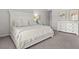 Bright bedroom with a decorative white bed frame, neutral bedding and a white dresser with floral prints above at 3952 Treebranch Cir Cir, Mount Pleasant, SC 29429