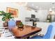 Dining room featuring a wooden table with decorative blue chairs and views into a well-equipped kitchen at 3952 Treebranch Cir Cir, Mount Pleasant, SC 29429
