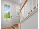 Light filled entry featuring a wood staircase, shuttered window and front door with large glass pane at 3952 Treebranch Cir Cir, Mount Pleasant, SC 29429