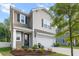 Charming home exterior with a manicured lawn, mature tree and two-car garage at 3952 Treebranch Cir Cir, Mount Pleasant, SC 29429