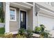 Charming front entrance with a black door, beige siding, and manicured landscaping at 3952 Treebranch Cir Cir, Mount Pleasant, SC 29429