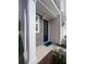 Inviting front entryway with a black door, neutral siding, and manicured landscaping at 3952 Treebranch Cir Cir, Mount Pleasant, SC 29429