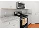 Close-up of a kitchen featuring stainless steel appliances, white cabinets, granite countertops, and grey subway tile backsplash at 3952 Treebranch Cir Cir, Mount Pleasant, SC 29429
