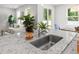 Kitchen island with stainless steel sink, granite countertops, and views into an open living area and dining space at 3952 Treebranch Cir Cir, Mount Pleasant, SC 29429