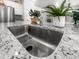 Close-up of a stainless steel kitchen sink with granite countertop and modern faucet at 3952 Treebranch Cir Cir, Mount Pleasant, SC 29429
