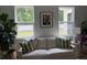 Bright living room showcasing a comfortable white sofa, stylish decor, and natural light from large windows overlooking the yard at 3952 Treebranch Cir Cir, Mount Pleasant, SC 29429