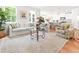 Sunlit living room flowing into kitchen with hardwood floors, neutral tones, and stylish furnishings at 3952 Treebranch Cir Cir, Mount Pleasant, SC 29429