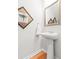 Well-lit powder room with pedestal sink, decorative mirror, and stylish wall art at 3952 Treebranch Cir Cir, Mount Pleasant, SC 29429