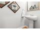 Clean powder room with pedestal sink, decorative mirror and wall art at 3952 Treebranch Cir Cir, Mount Pleasant, SC 29429