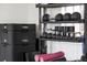 Well-equipped fitness area with storage shelves containing weights, mats, and other exercise gear at 3997 Chantey Crest, Johns Island, SC 29455
