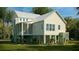Rear exterior view of a charming two-story home featuring a screened porch and well-maintained lawn at 3997 Chantey Crest, Johns Island, SC 29455