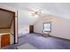 Spacious finished attic featuring purple carpet, ceiling fan, and natural light from the window at 415 Whitebark Dr, Ladson, SC 29456