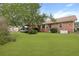 Spacious backyard featuring a well-maintained lawn, mature trees, and a charming outdoor deck with an attached gazebo at 415 Whitebark Dr, Ladson, SC 29456