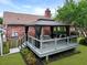Backyard deck with black gazebo, accessible by steps and offering a serene outdoor space, enhancing relaxation and entertaining at 415 Whitebark Dr, Ladson, SC 29456
