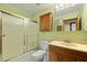 Bathroom with a shower-tub combo, vanity, wooden cabinets, and a mirror at 415 Whitebark Dr, Ladson, SC 29456