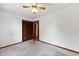 Neutral bedroom with ceiling fan and an open dark wood closet at 415 Whitebark Dr, Ladson, SC 29456