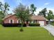 Charming brick home with well-maintained landscaping, mature trees, and a cozy front porch at 415 Whitebark Dr, Ladson, SC 29456