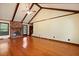 Spacious living room with vaulted ceilings, wood beams, a brick fireplace, and hardwood flooring at 415 Whitebark Dr, Ladson, SC 29456