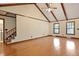 Open-concept living room with hardwood floors, vaulted ceilings, and large windows at 415 Whitebark Dr, Ladson, SC 29456
