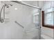 Newly renovated shower with grab bar, shelving, and glass doors at 415 Whitebark Dr, Ladson, SC 29456